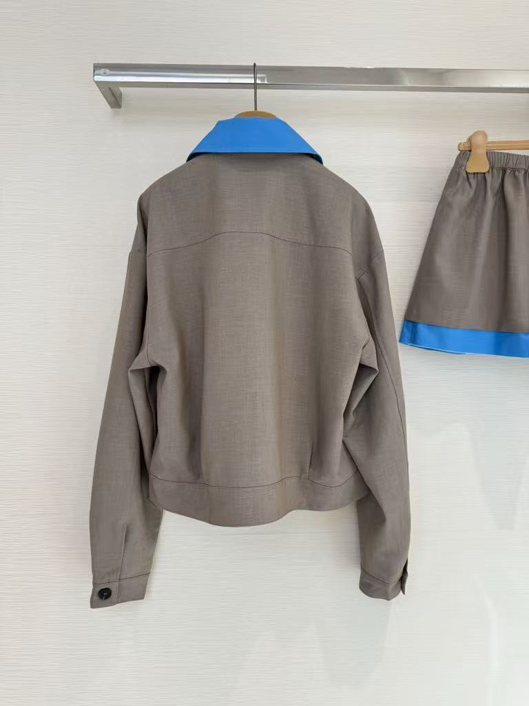 New for early fall, this lapel-embroidered, color-blocked jacket and skirt pair.