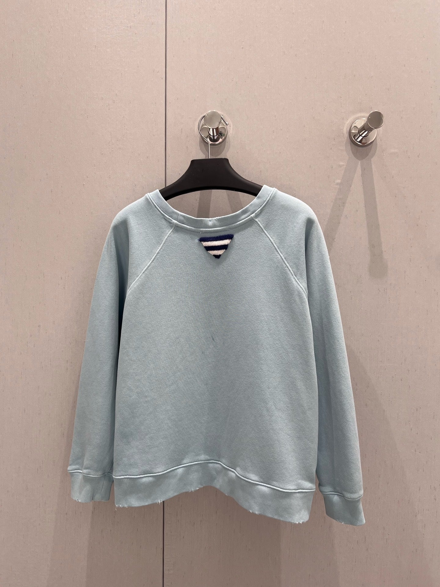 Light blue sweatshirt with distressed design