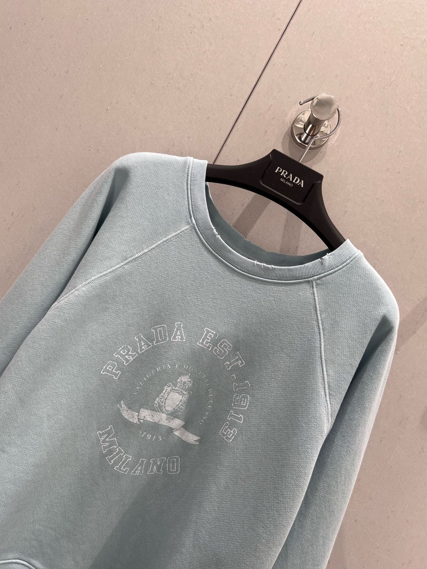 Light blue sweatshirt with distressed design