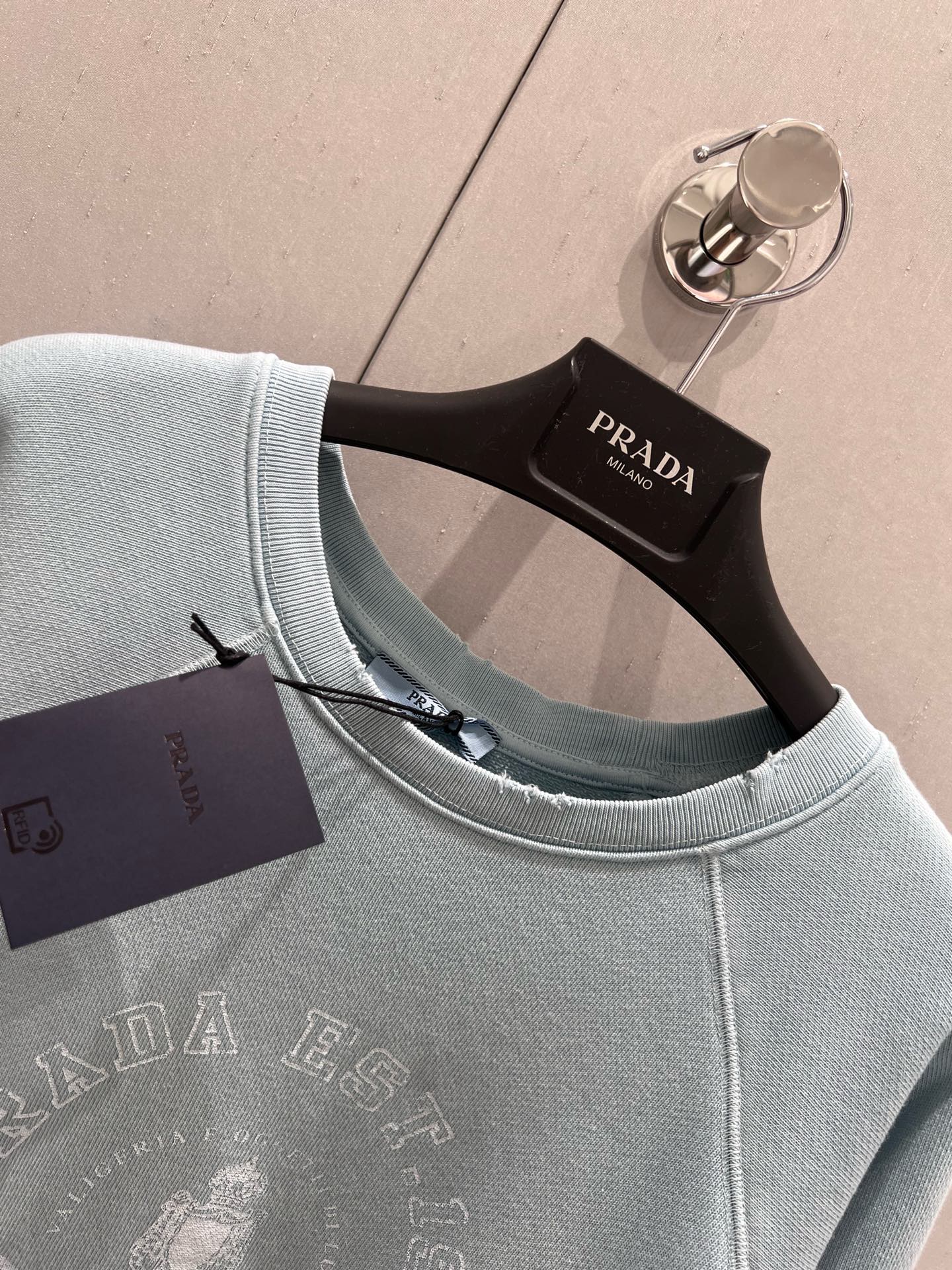 Light blue sweatshirt with distressed design