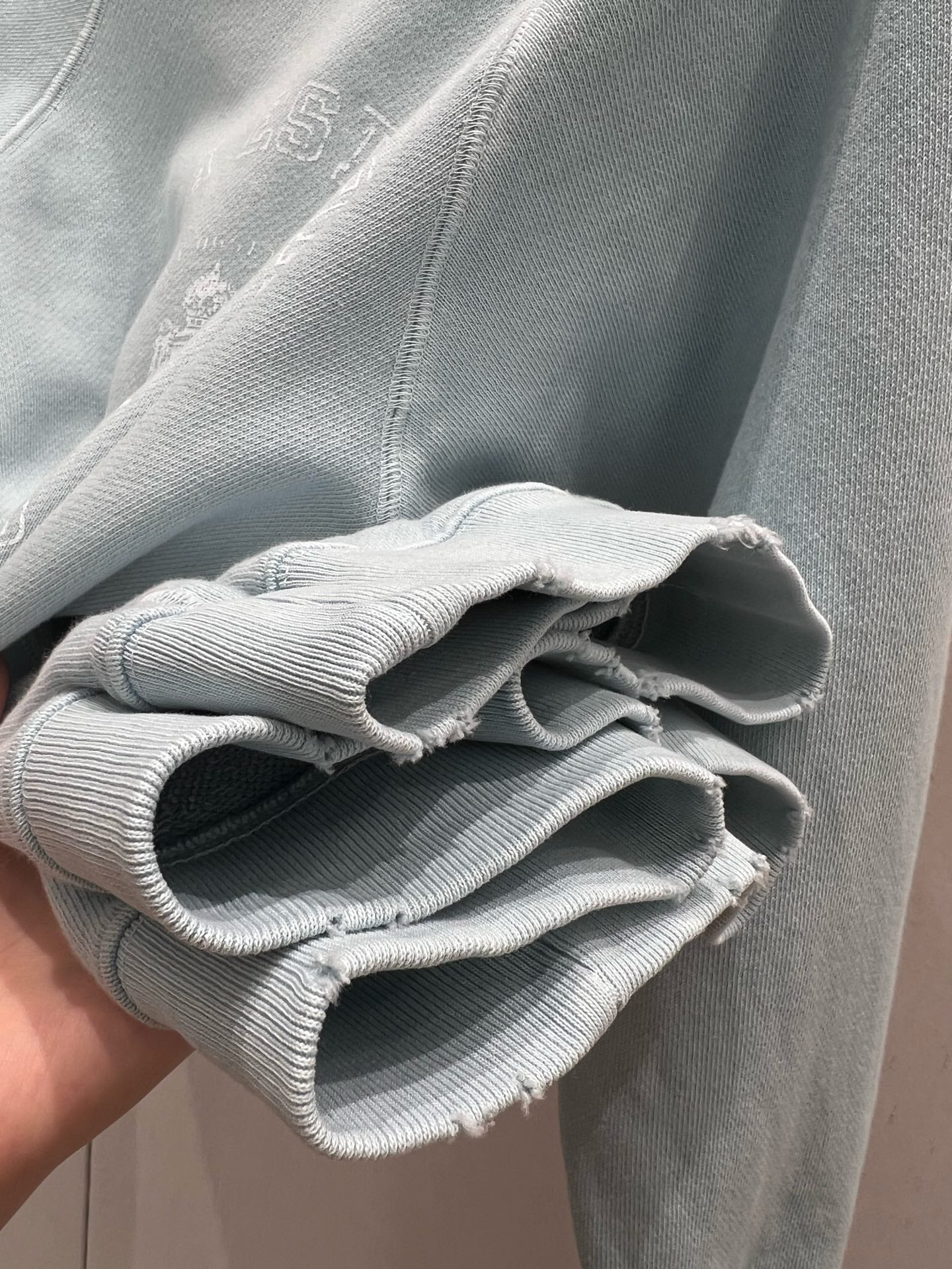 Light blue sweatshirt with distressed design